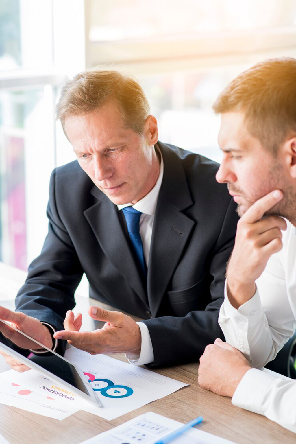 two-businessman-discussing-business-plan-digital-tablet_23-2147899917